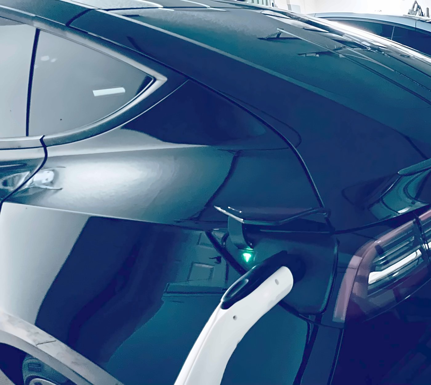 Electric vehicle plugged into a Level 2 home EV charger