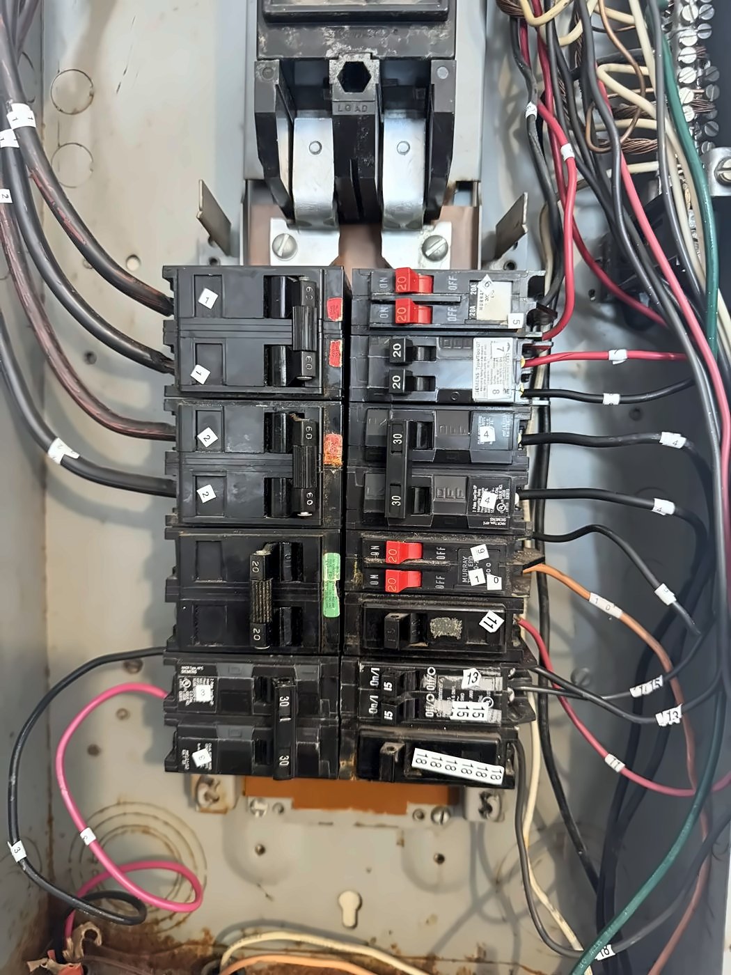 Old panel breakers and wiring before a panel replacement