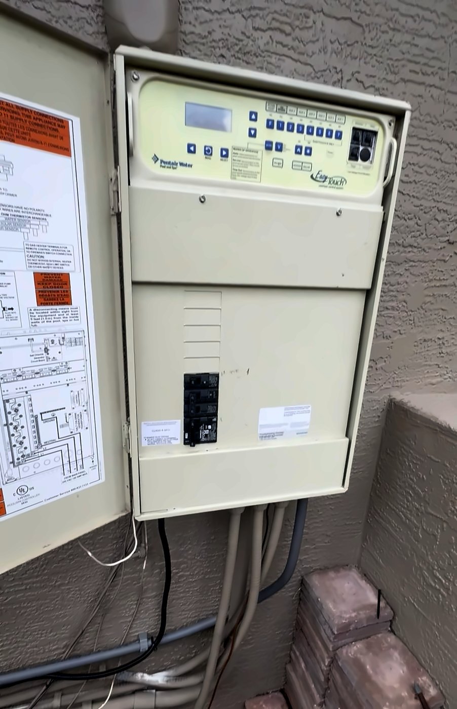 Pentair EasyTouch pool automation control panel on an exterior wall